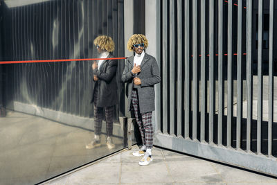 People standing by railing in city