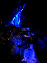 Illuminated firework display at night