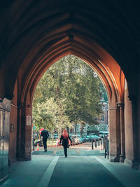 Rear view of people walking in historic building