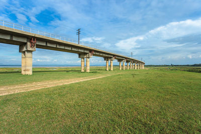 View of bridge on field against sky