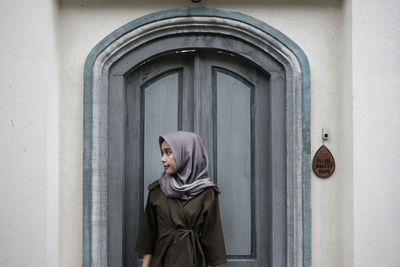 Portrait of woman with close door