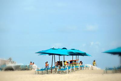 People relaxing on beach