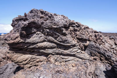 Low angle view of rock formation on land against sky