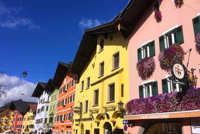Low angle view of buildings against blue sky