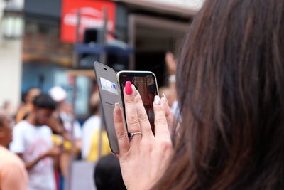 Midsection of woman using mobile phone