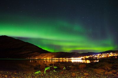 Scenic view of illuminated mountains against sky at night