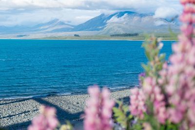Scenic view of sea and mountains against sky