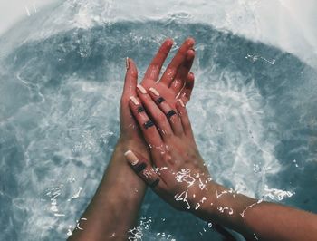 Cropped hands in water