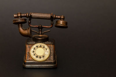 Close-up of telephone booth against black background