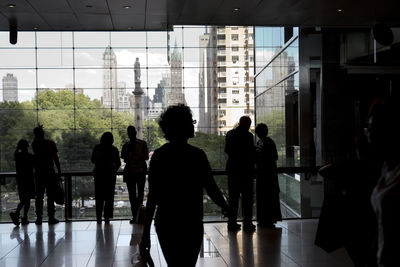 Silhouette of people walking in modern building