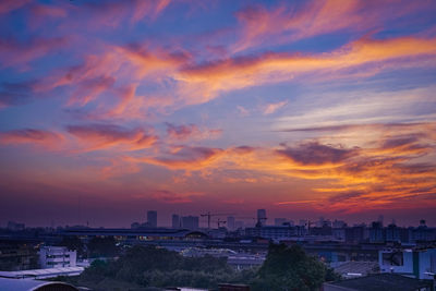 Buildings against cloudy sky during sunset