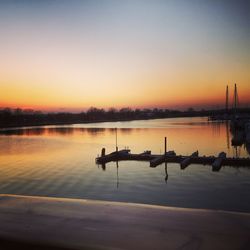 Scenic view of calm lake at sunset