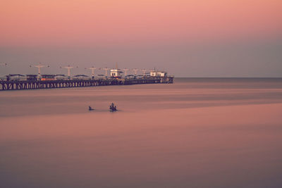 Scenic view of sea against clear sky at sunset