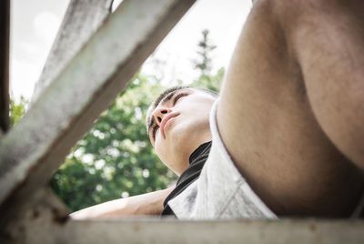 Low angle view of man looking away outdoors