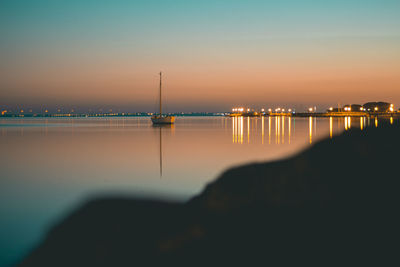 Scenic view of sea against clear sky at sunset