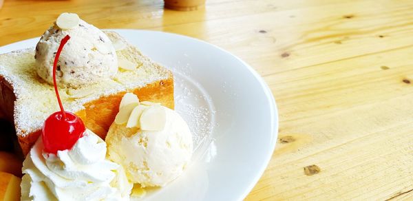 High angle view of icecream with bread  on table