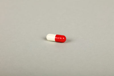 Close-up of red wine on table against white background