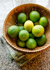 High angle view of lemons in basket on table
