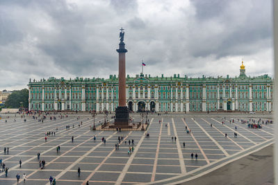 Buildings in city against cloudy sky