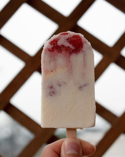 Close-up of hand holding ice cream cone