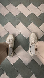 Low section of woman standing on tiled floor