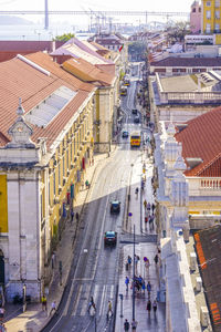 High angle view of vehicles on road along buildings