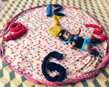 High angle view of girl sleeping on bed