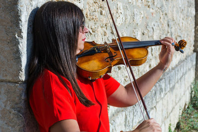 Close-up of woman playing violin