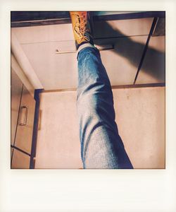 Low section of person wearing canvas shoes