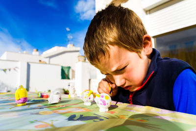 Close-up portrait of boy on table