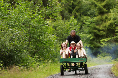 Happy girls having ride on cargo bike