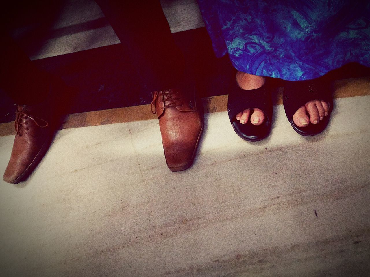 LOW SECTION OF WOMAN WEARING SHOES ON FLOOR