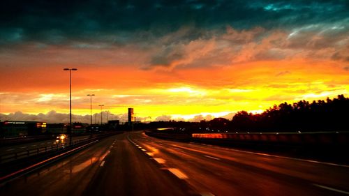 Road against cloudy sky at sunset