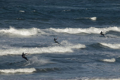 People kiteboarding in sea