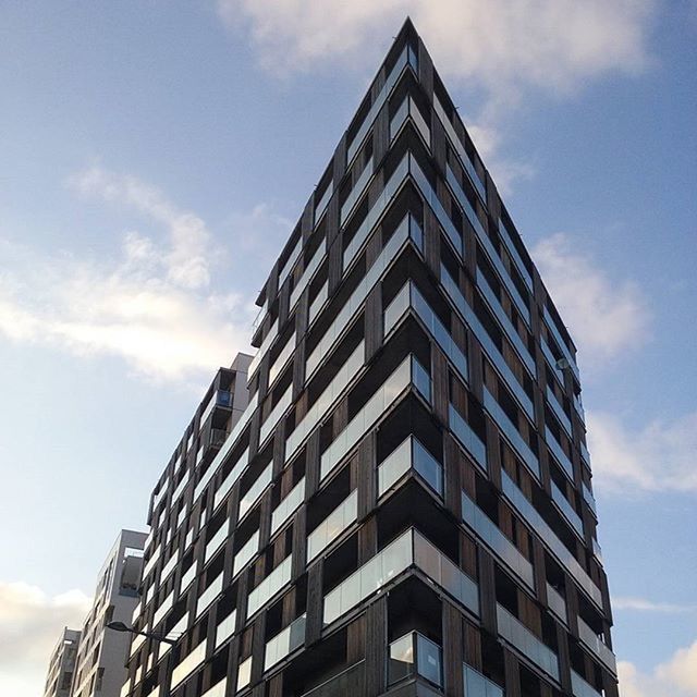 building exterior, architecture, built structure, low angle view, sky, modern, city, cloud - sky, office building, cloud, building, tall - high, window, skyscraper, day, reflection, tower, glass - material, outdoors, cloudy