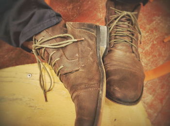 Low section of man standing on tiled floor
