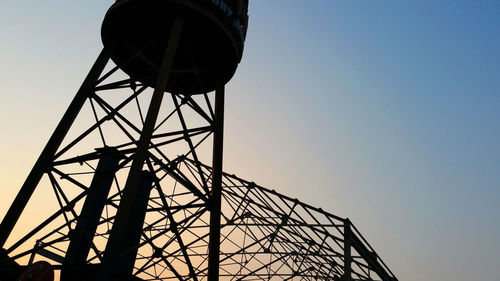 Low angle view of water tower against clear sky