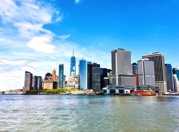 River by buildings against sky in city