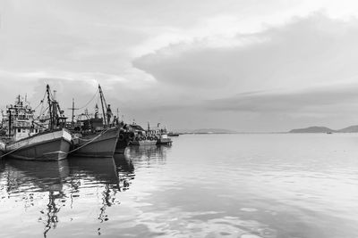 Boat moored in sea against sky