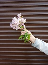 Midsection of woman holding flower bouquet