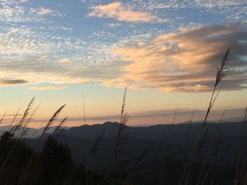 Silhouette landscape against sky during sunset