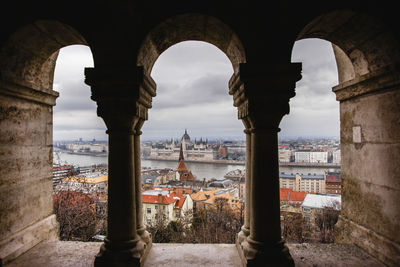 View of old buildings against cloudy sky