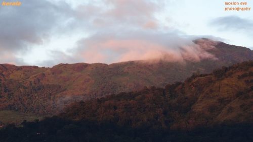 Scenic view of mountains against cloudy sky