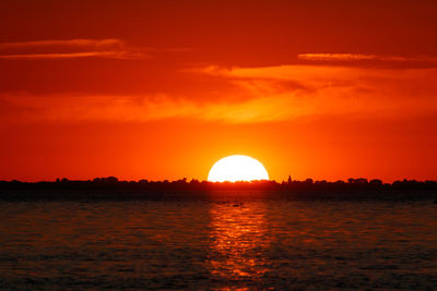 Scenic view of sea against romantic sky at sunset