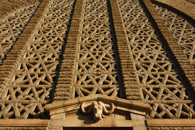 Low angle view of sculpture on roof of building