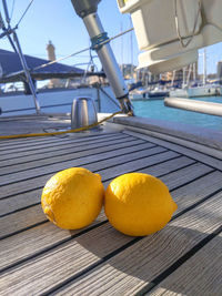 Close-up of fruits on table against swimming pool