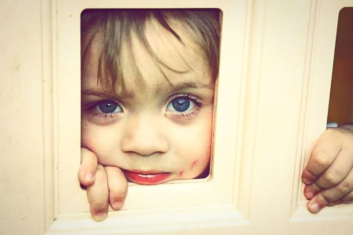 child, childhood, one person, portrait, looking at camera, toddler, human face, skin, baby, headshot, eye, indoors, emotion, human eye, innocence, female, smiling, cute, person, human head, women, hand, close-up, blue eyes, front view, fun, men, window, looking, happiness, peeking, lifestyles, picture frame