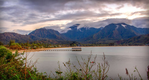 Scenic view of lake and mountains against sky