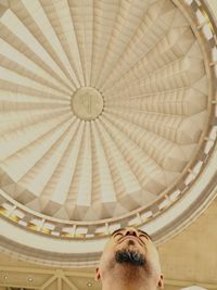 Low angle view of man on ceiling