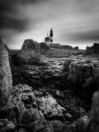 Lighthouse against cloudy sky